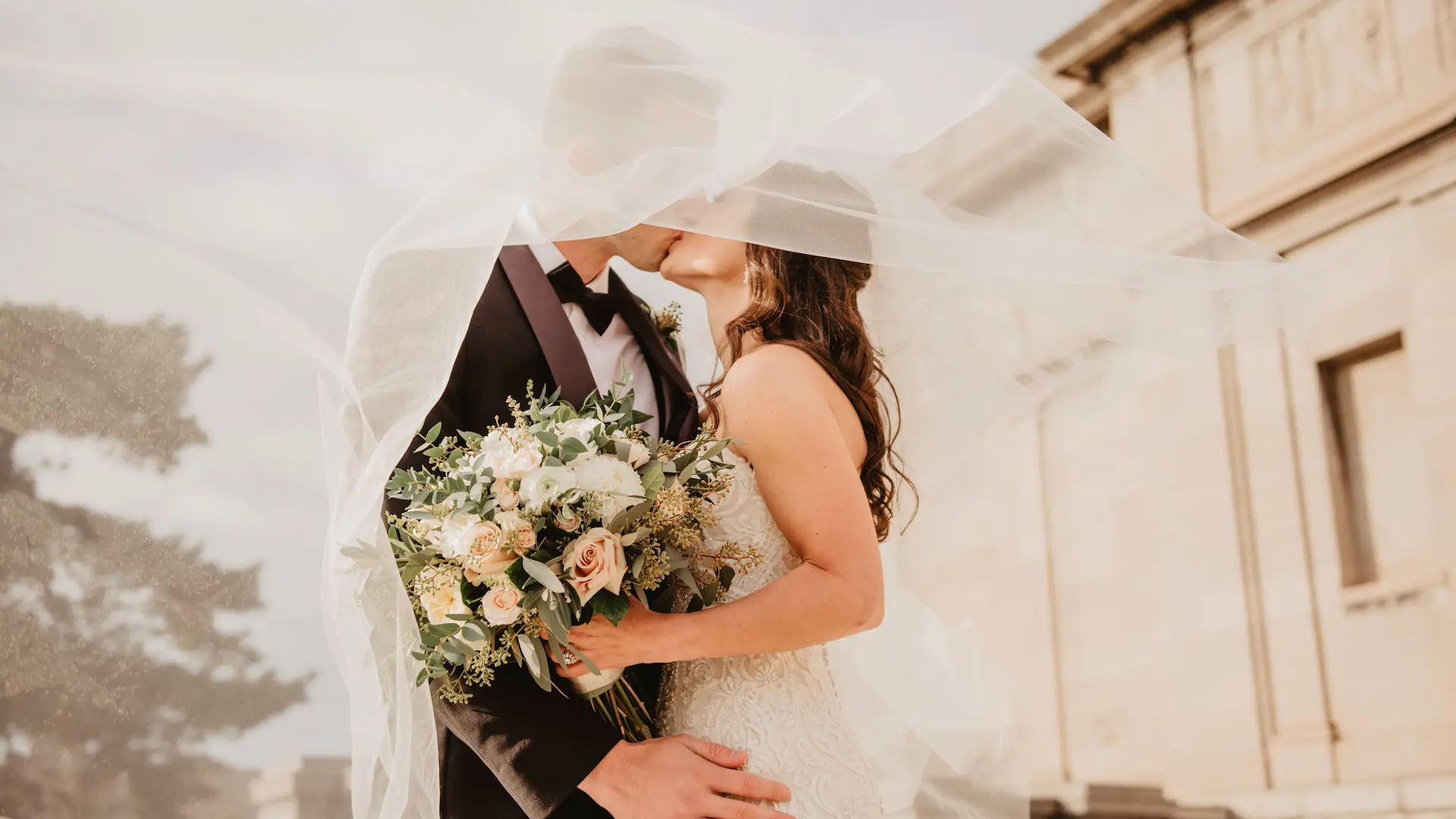 Bride and groom kissing under her veil — New Legacy Films wedding photography