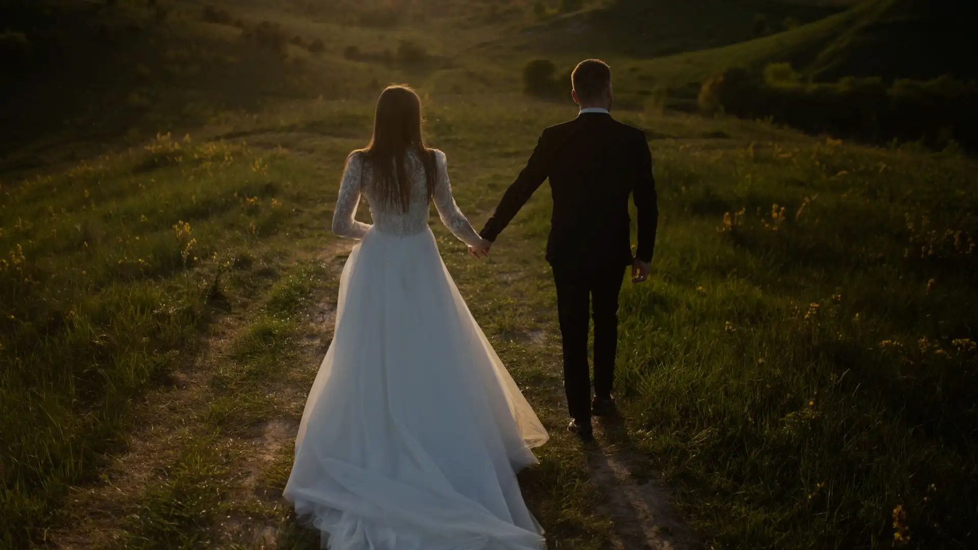 Sacramento wedding couple holding hands at golden hour in a garden — New Legacy Films